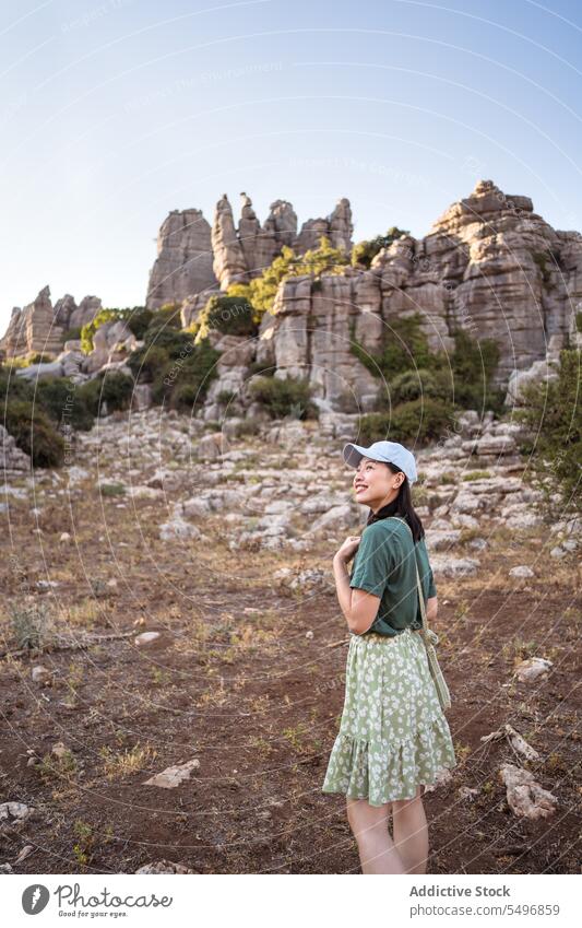 From below woman admiring view of rocky terrain traveler admire el torcal de antequera mountain spectacular landscape summer weekend female asian