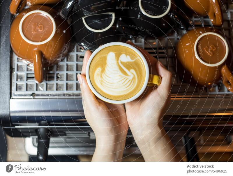 Crop woman with cup of latte coffee hot drink aromatic mug tasty machine caffeine kitchen breakfast delicious energy fresh cafe coffeemaker flavor refreshment