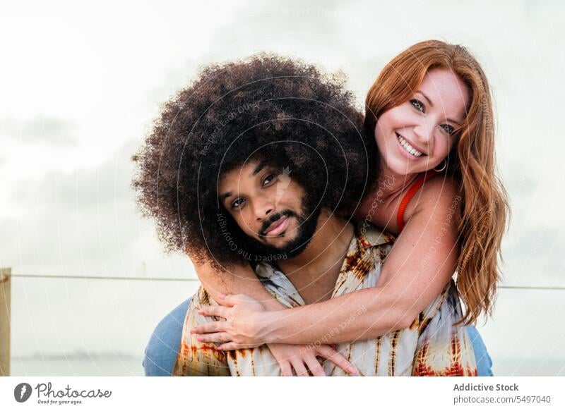 Smiling black couple relaxing near sea under sky embankment happy positive contemplate together smile relationship diverse multiracial young girlfriend