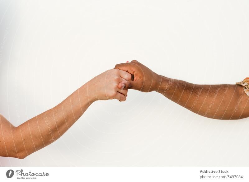 Crop diverse couple giving high five to each other hand hands together bonding support tolerance unity relationship equal boyfriend girlfriend multiracial