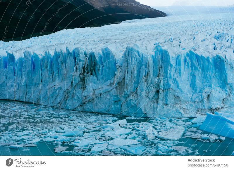 Amazing view of turquoise ice glacier lake with mountains frozen snow winter iceberg nature cloudy water scenic frost sky picturesque weather landscape cold