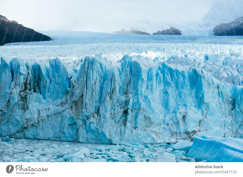 Amazing view of turquoise ice glacier lake with mountains frozen snow winter iceberg nature cloudy water scenic frost sky picturesque weather landscape cold