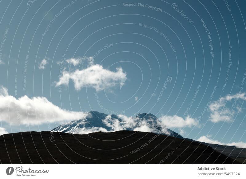 Volcano covered with snow on sunny day volcano ecological reserve landscape environment nature valley cloud antisana ecuador south america picturesque blue sky