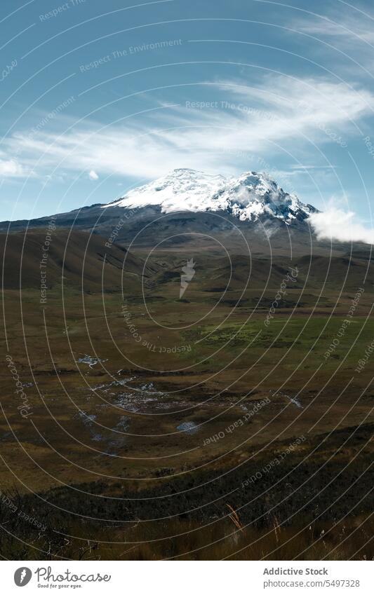 Volcano covered with snow on sunny day volcano ecological reserve landscape environment nature valley cloud antisana ecuador south america picturesque blue sky