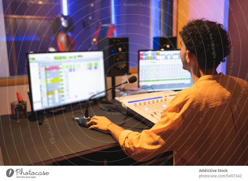 Man approving while recording vocal sound in studio audio engineer singer song music thumb up performer voice technician create produce mixer equalizer panel