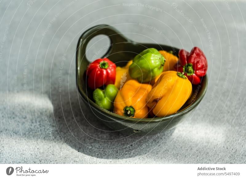 From above of different colored peppers bowl colorful vegetable food raw yellow orange fresh natural healthy gastronomy explosion ripe mix ingredient cook