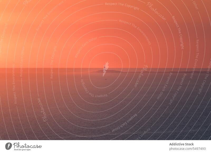 Lonely lighthouse against sunset sun Strait of Gibraltar Morocco maritime transport sea orange beacon seascape hill sky sundown magnificent coast shore