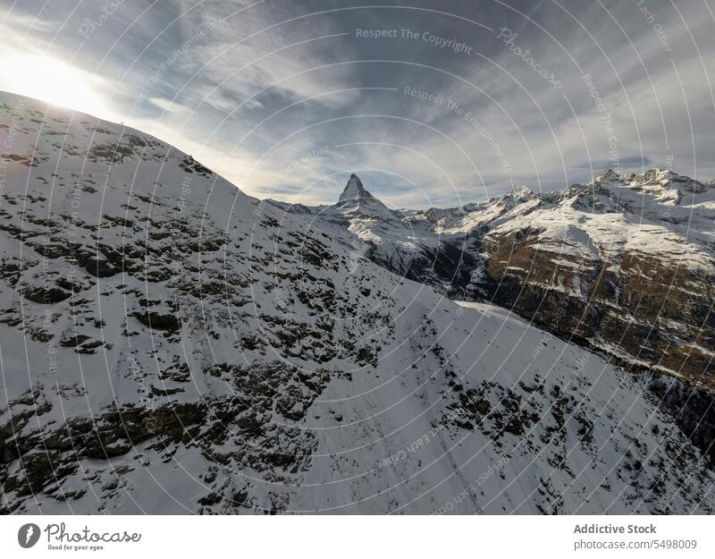 Snowy mountains in winter snow gloomy frozen cold landscape rock nature park coast scenic sky cloudy environment scenery shore ridge range wild dark overcast