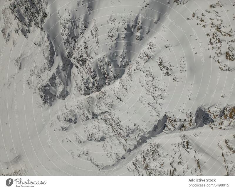 Snowy mountains in winter snow gloomy frozen cold landscape rock nature park coast scenic sky cloudy environment scenery shore ridge range wild dark overcast