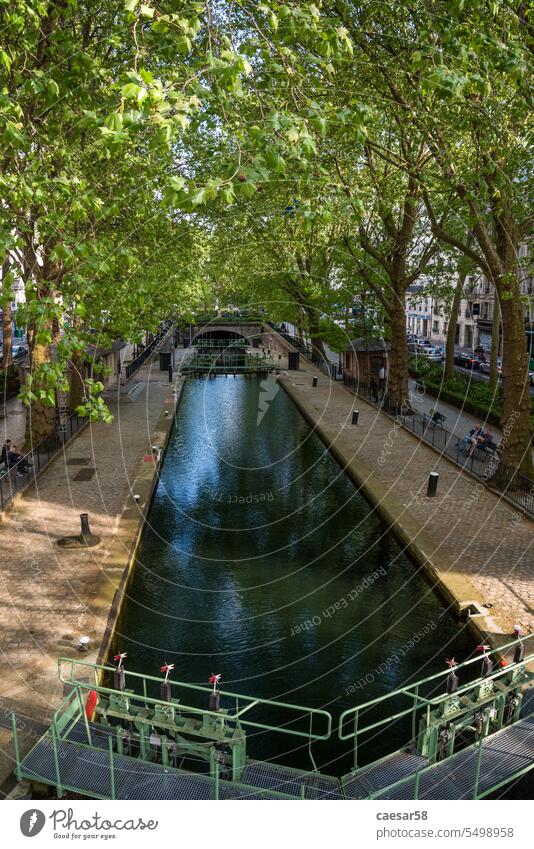 Calm canal Saint Martin in Paris in Summer canal saint martin france bridge paris city tree waterway transport landscape europe lock trees architecture tourism