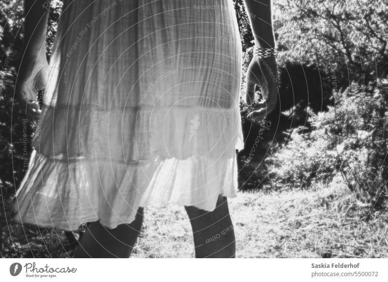 Woman in sheer dress, monochrome woman silhouette black and white skirt backlit evening light sunshine garden cotton figure movement contrast Shadow Sunlight