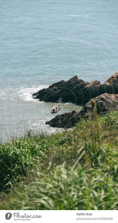 Fishing boat between rocks scenery fishing Ocean Coast China Island Water seascape coastline Fisherman boats travel Far-off places Adventure Travel photography