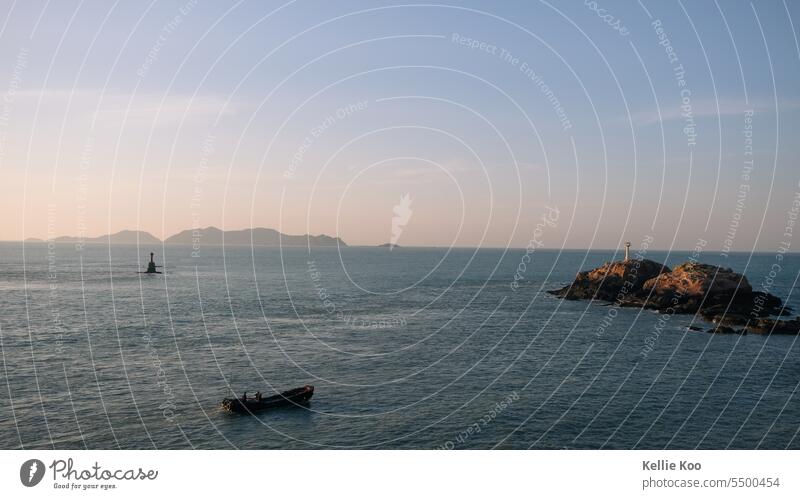 Boat among islands Island boat Islands Water Ocean Fishing boat China fishing Blue Sunset Vacation & Travel Far-off places Coast Dusk dusky pink Vastness