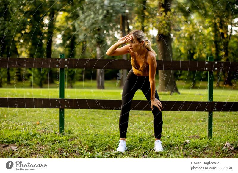 Pretty young woman resting after outdoor training caucasian jogger sport lifestyle active activity adult athlete athletics track beautiful beauty body close up