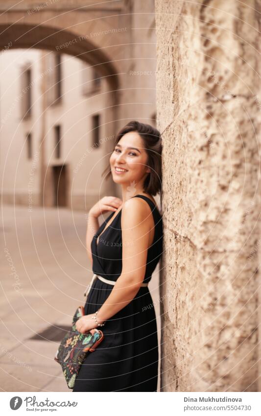 retro portrait of a smiling woman closeup. Beautiful woman at street of historic town. Gorgeous girl sightseeing in Europe. Confident woman, solo female traveler. Glamour and chic, fashion and style concept.