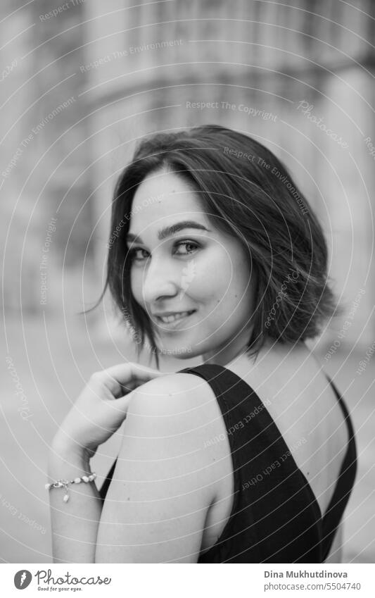 retro portrait of a smiling woman closeup. Beautiful woman at street of historic town. Gorgeous girl sightseeing in Europe. Solo female traveler. Glamour and chic, fashion and style concept.