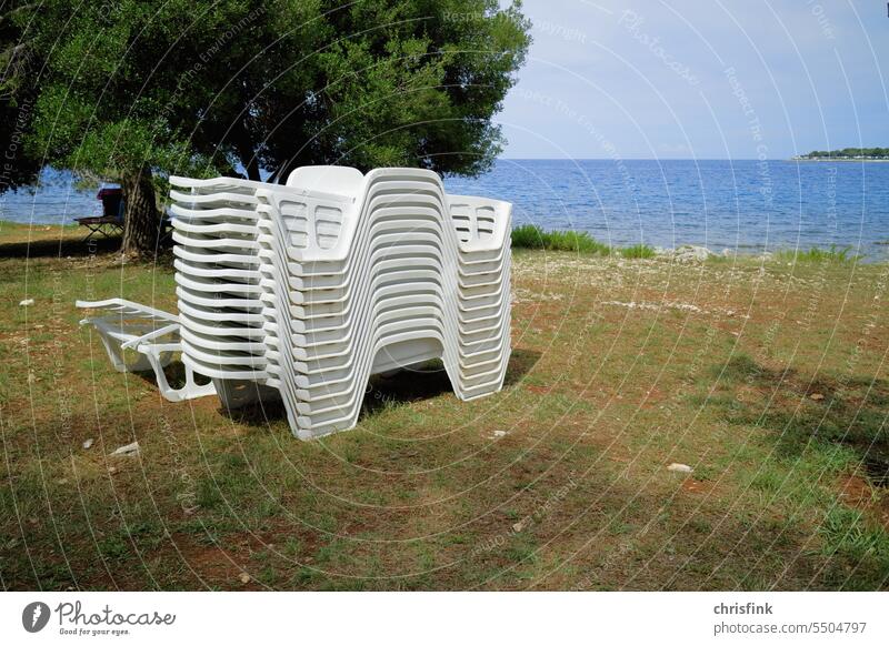 Deck chairs stacked on beach Chair Deckchair Beach lido vacation holidays Vacation & Travel Tourism Summer vacation Colour photo Sunbathing Relaxation coast