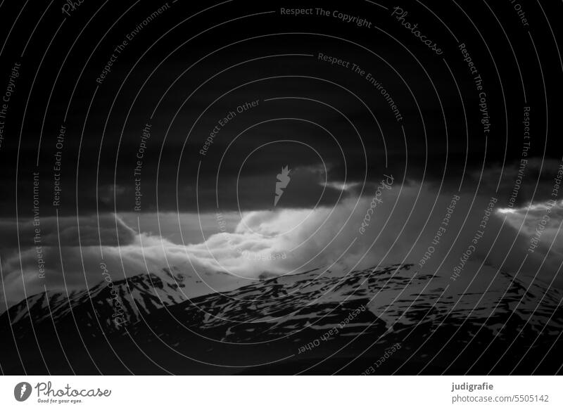 Iceland with dark sky Mountain Snow Landscape Snowcapped peak Cold Climate Nature Clouds Peak Sky Moody Dark naturally Threat threatening sky Weather Light