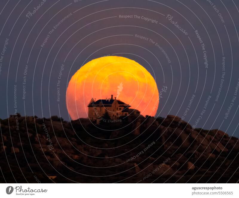 supermoon rising behind the palace of Canto del Pico, Torrelodones, Madrid; in Spain. golden astrophotography covering fields spain light full moon moonlight