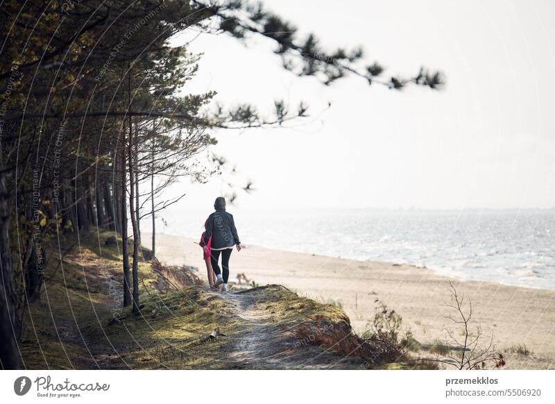 Family walking in forest along beach. Summer vacation trip close to nature. People actively spending leisure time. Enjoying long walk during summertime. Travel concept