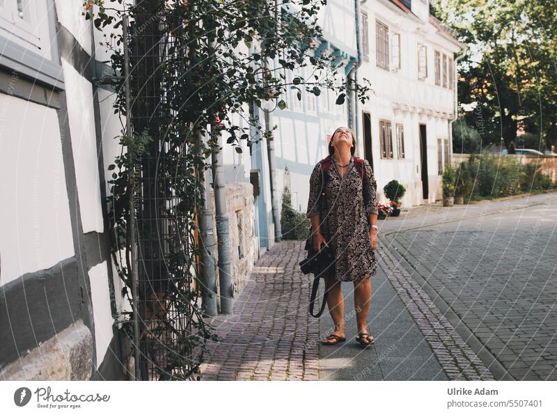 Drinkje bej inkje | woman standing in an old alley, looking up and admiring a rose Woman Alley Wolfenbüttel Half-timbered houses climbing rose