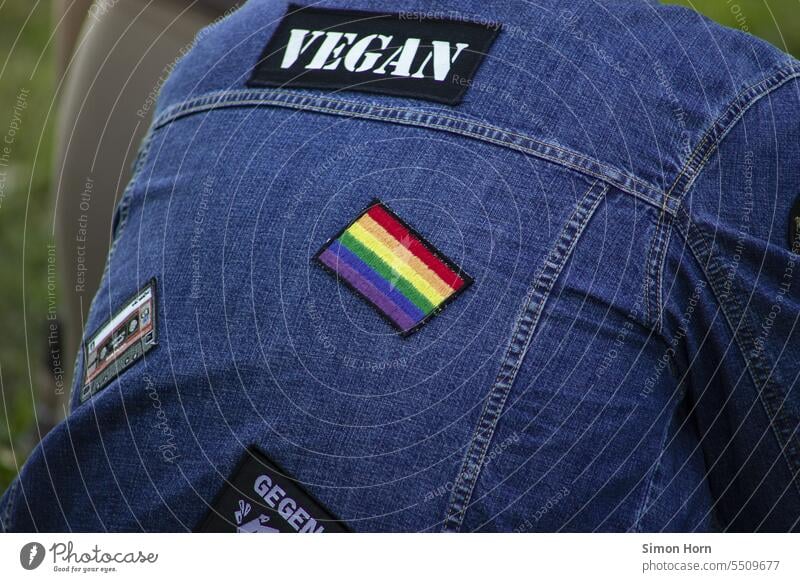 Patches on a denim jacket as symbols of a new attitude to life patch Symbols and metaphors LGBTQ vegan against racism Rainbow Tolerant variety protest Protest