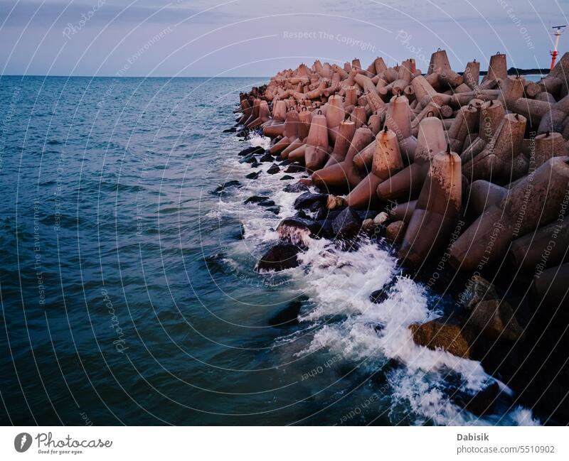 Tetrapod breakwater at sea coast for protecting from waves tetrapod barrier infrastructure shoreline construction port sunset harbor coastline baltic