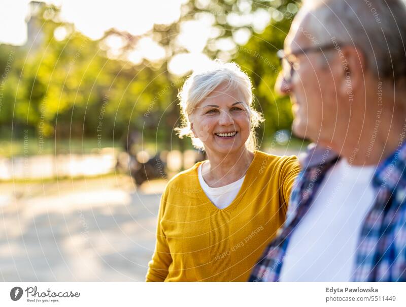 Portrait of happy senior couple standing in city street on a sunny day people caucasian healthy city life gray hair enjoy casual portrait outside real people