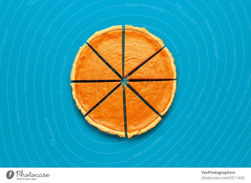 Sliced pumpkin pie top view, minimalist on a blue table Halloween above autumn background baking bright brown cake celebration christmas color comfort concept