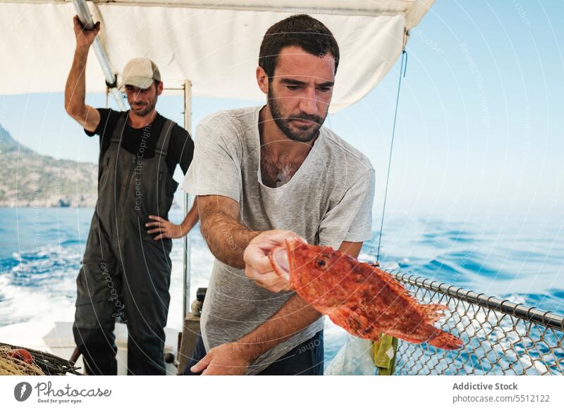 Fishermen on yacht fishing in sea bass serious boat float sailboat male soller mallorca balearic island summer vessel fisher water ocean nautical nature marine