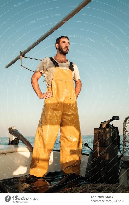 Thoughtful seaman enjoying spectacular view from fishing boat in sunset fisher sail net trawler admire seascape male soller balearic islands mallorca fisherman