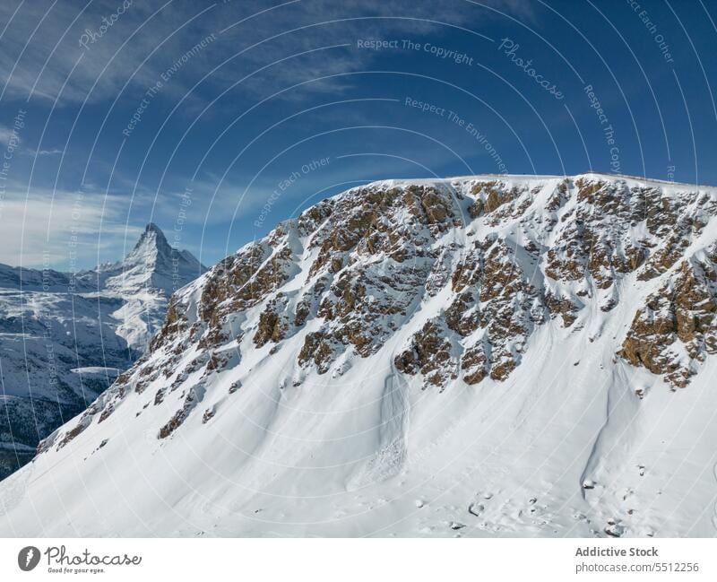 Snowy mountains under blue sky snow nature highland landscape Zermatt winter ski resort magnificent rough Switzerland ridge dry bumpy scenic atmosphere uneven