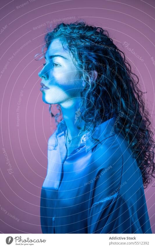 Attractive woman with curly hair in room with neon lights portrait effect illuminate dot calm peaceful tranquil sensual young female lady long hair human face