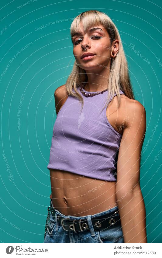 Confident woman with looking at camera hipster portrait natural body accept studio shot confident self confident self assured female young blond bangs piercing