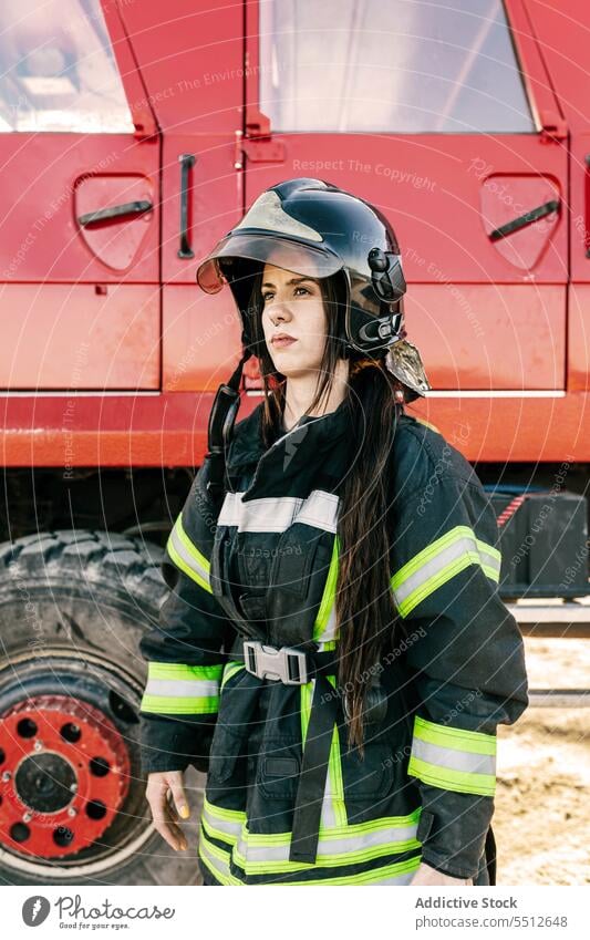 Woman firefighter in protective uniform and helmet woman safety occupation job female service professional emergency vehicle work workwear transport worker