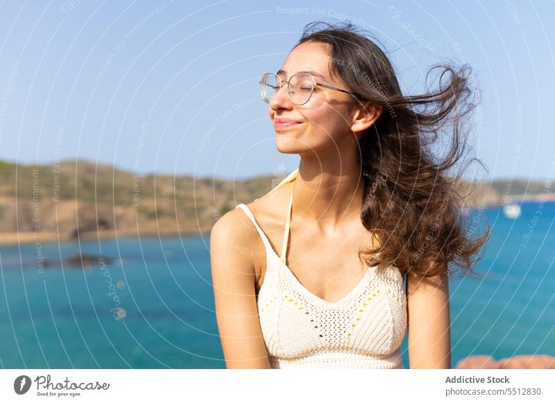 Young woman near sea in summer day travel tourist vacation trip nature ocean female glasses holiday water young tourism marine spain seascape summertime journey