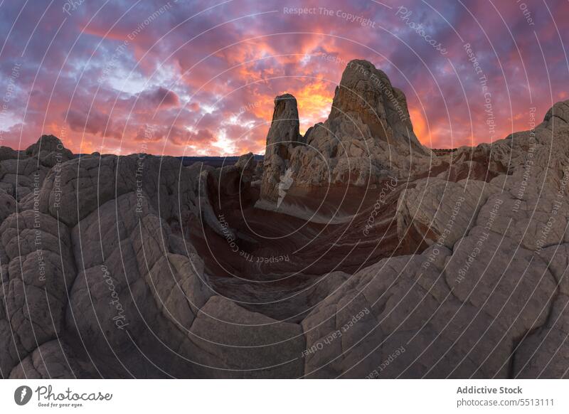 Rocky mountains under bright sky at sunset picturesque cloudy rocky sundown highland uneven nature landscape ridge rough formation stone scenery purple scenic