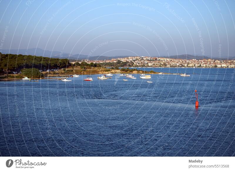 View from a bridge on the peninsula in Cunda to the coast and bay of Ayvalik with blue sea and colorful boats on the Aegean Sea in Balikesir province, Turkey