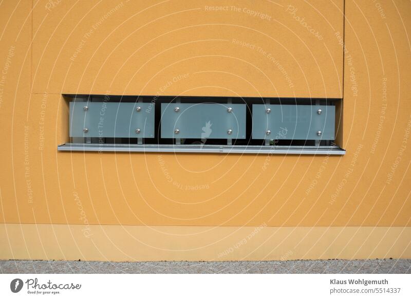 Tastefully clad wall opening on a modern building. Frosted glass and stainless steel create a beautiful contrast with the orange brickwork Architecture Window