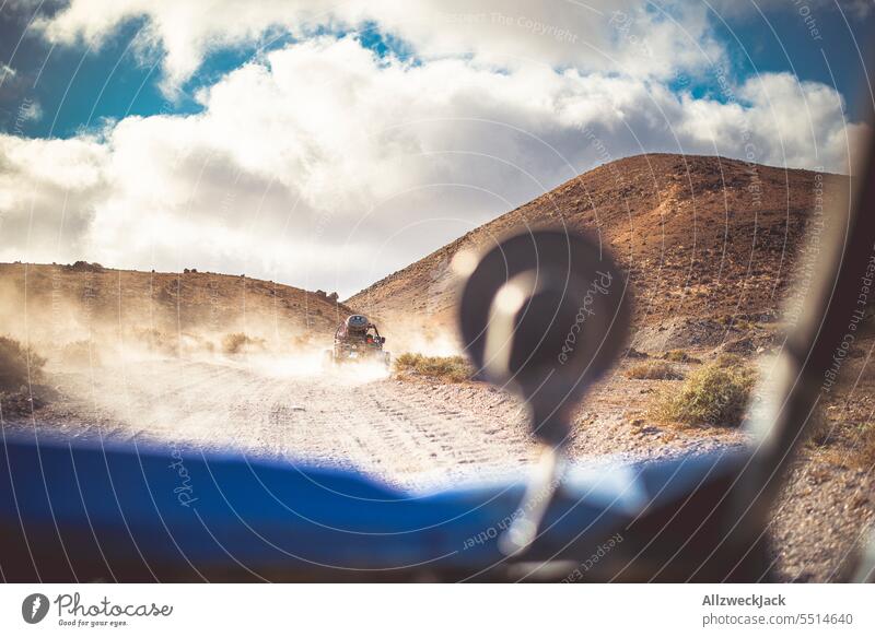 Camera perspective from a buggy during an offroad ride Summer Summer vacation Offroad Buggy outdoor mogul slope Dust Cloud of dust Dusty route