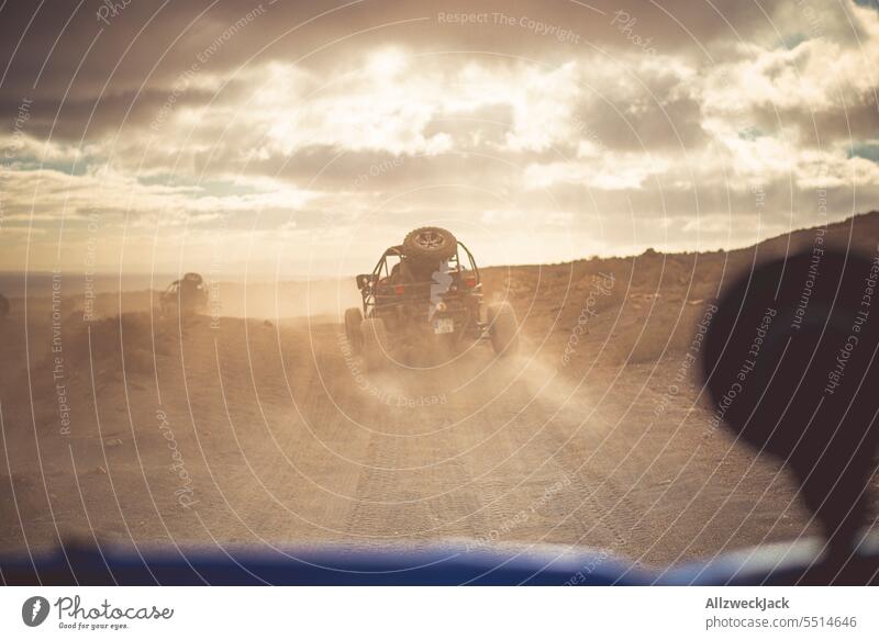 Camera perspective from a buggy during an offroad ride Summer Summer vacation Offroad Buggy outdoor mogul slope Dust Cloud of dust Dusty route