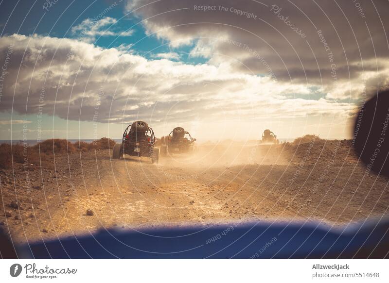 Camera perspective from a buggy during an offroad ride Summer Summer vacation Offroad Buggy outdoor mogul slope Dust Cloud of dust Dusty route