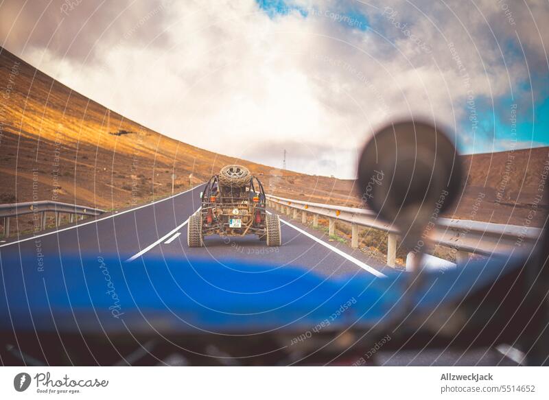 Camera perspective from a buggy during a ride on a road Summer Summer vacation Offroad Buggy outdoor Dust Cloud of dust Dusty route off the beaten track Rally