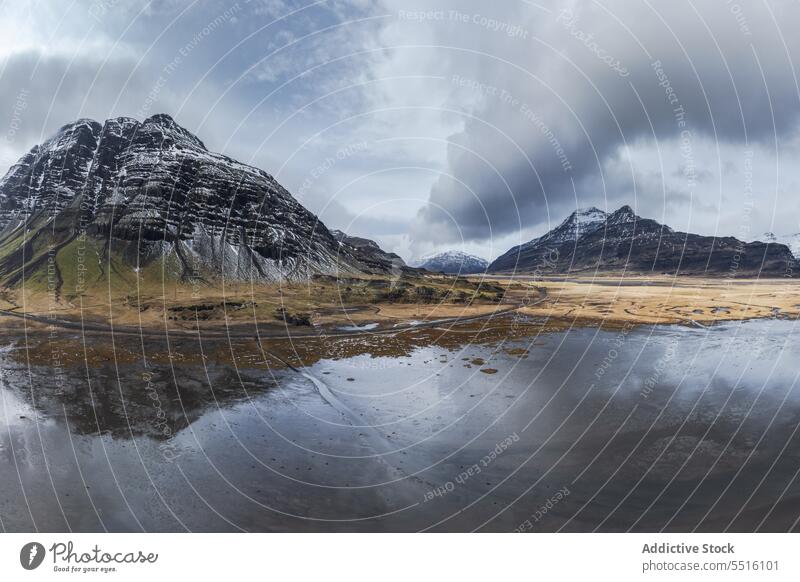 Majestic mountains in Iceland near lake majestic water crystal huge snow cloudy sky cold nature environment weather valley atmosphere iceland climate frozen