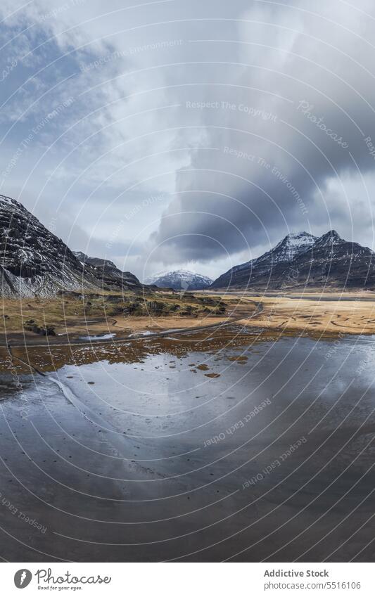 Majestic mountains in Iceland near lake majestic water crystal huge snow cloudy sky cold nature environment weather valley atmosphere iceland climate frozen