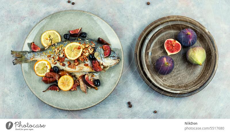 Tasty roasted dorado or gilt head bream fish dorada seafood almonds figs healthy dinner lemon grilled diet baked dish cuisine Mediterranean whole lunch prepared