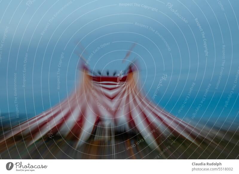 Blurred ICM shot of red and white striped circus tent against blue sky Circus tent Circus tents ICM technology Stripe Reddish white Colour photo colourful