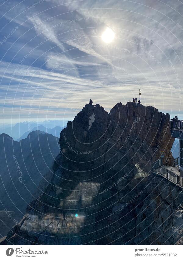 The Zugspitze with summit cross in the backlight in September 2023. /. Photo: Alexander Hauk vacation travel free time Tourism mountains Summer Sun sunshine