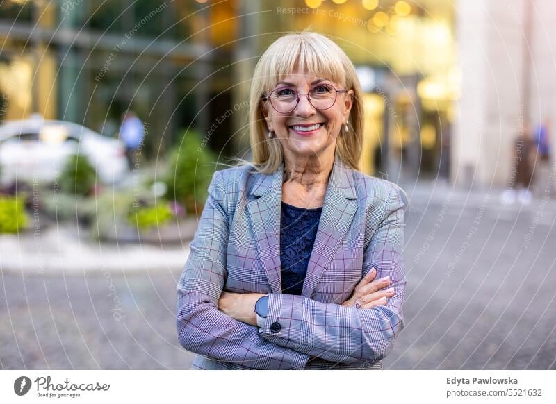 Portrait of smiling senior businesswoman in the city natural enjoy satisfied cheerful confident pensioner outdoors outside eyeglasses elderly happiness older