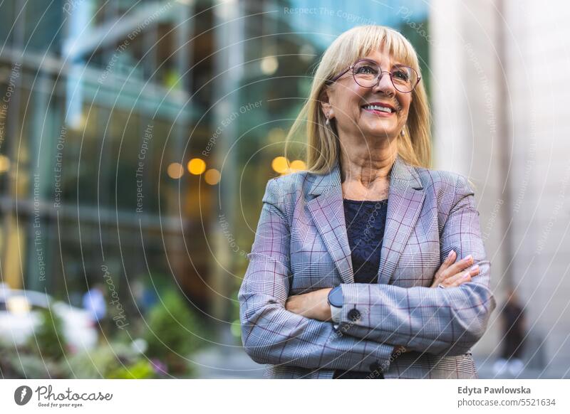 Portrait of smiling senior businesswoman in the city natural enjoy satisfied cheerful confident pensioner outdoors outside eyeglasses elderly happiness older